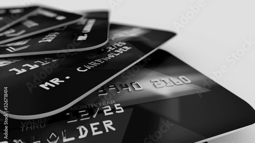 Optical art 3d rendering of black banking credit cards with stripes of digits in a black and grey palette placed like cards on a table in the white studio. Seamless loop.
