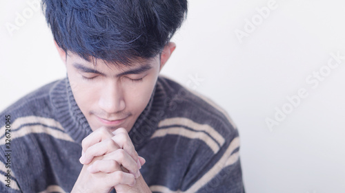 Asian Man Pray with God for the whole world to pass on the corona virus together.              