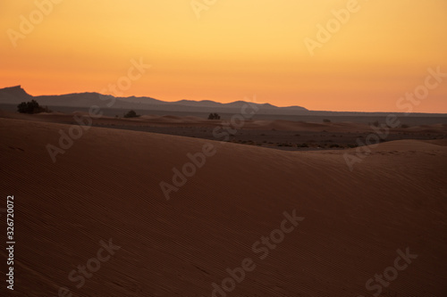 Beautiful  orange  early sunrise on the erg chebbi  sahara desert in Marzouga  Morocco.