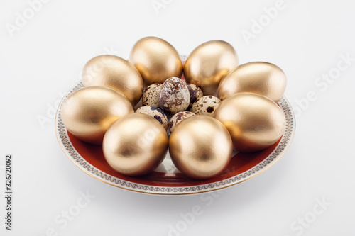 Pattern of Golden eggs and quail, on a white background. Easter concept, a symbol of the holiday.