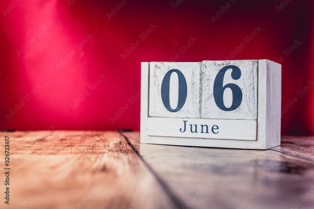 June 6th. Day 6 of month, calendar on business office table, workplace with vivid maroon red background. Summer time June 6th. Day 6 of month, calendar on business office table, workplace with vivid maroon red background. Summer time