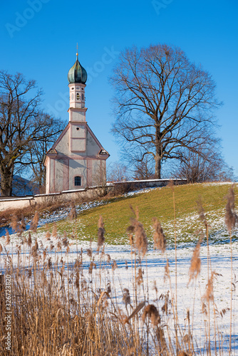 pilgrimage church Ramsach, near Murnau, blue sky and rests of snow, vertical photo