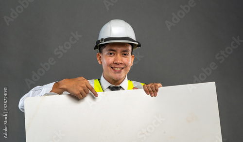 Cpnstruction worker holding hite board. photo