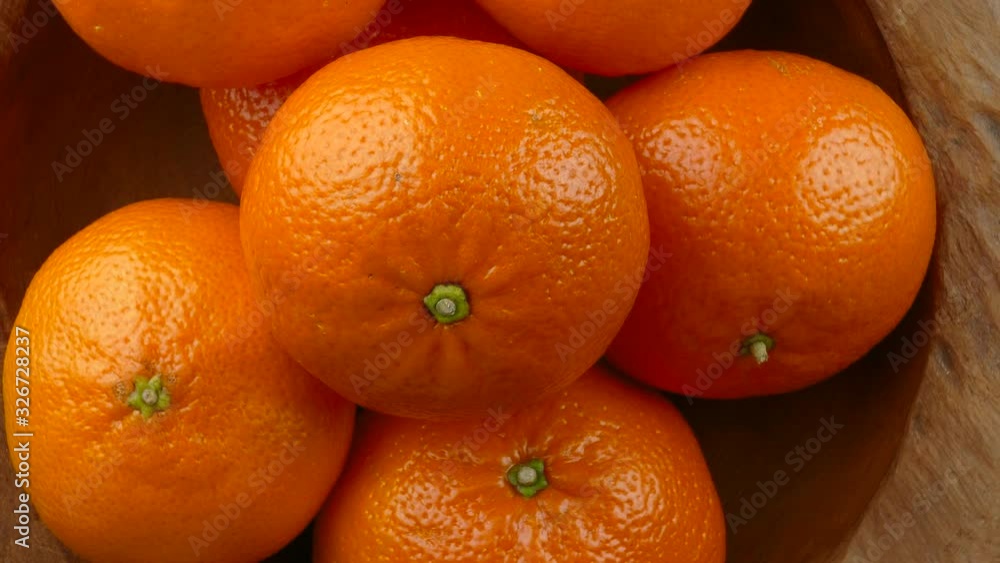 fresh mandarin orange fruits in a wooden bowl rotating top view 4k fresh mandarin orange fruits in a wooden bowl rotating top view 4k