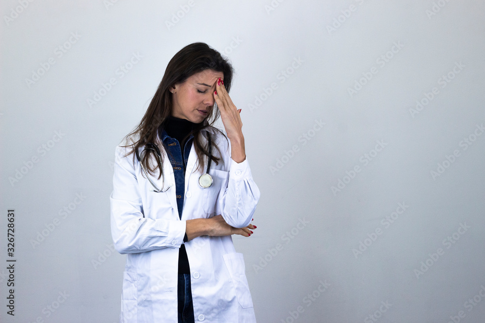 Portrait of pretty caucasian middle age woman model touches his forehead and having headache. Doctor, veterinarian, pharmacist, scientist, therapist, teacher, isolated on gray background studio shot, Portrait of pretty caucasian middle age woman model touches his forehead and having headache. Doctor, veterinarian, pharmacist, scientist, therapist, teacher, isolated on gray background studio shot,