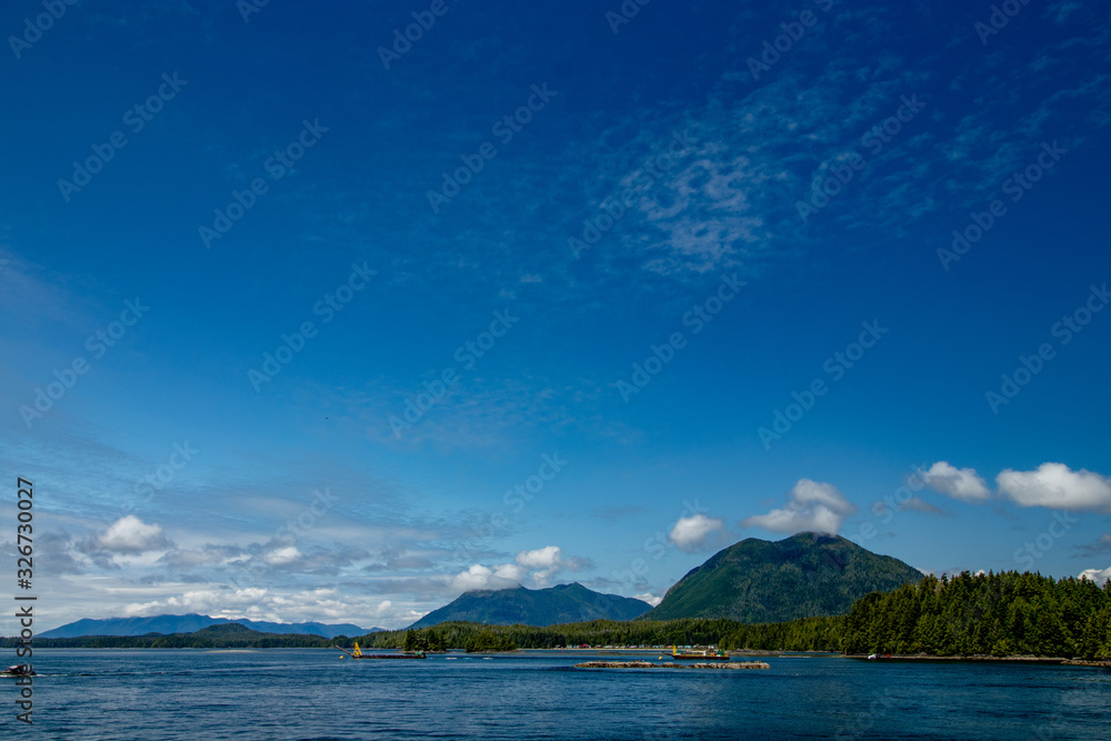 Beautiful clouds, sky and mountains seen from Tofino harbor - Tofino, Vancouver Island, BC, Canada