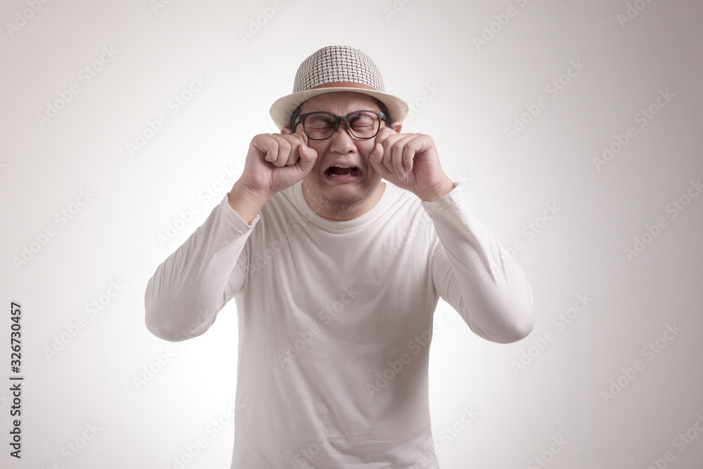 Naklejka premium Funny Asian Man Crying