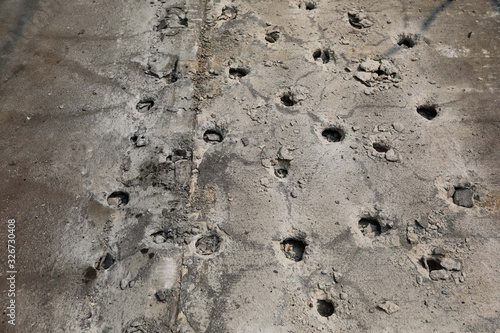 Pattern of Boring holes in old ground road by drilling rig machine. industrial concrete drilling at construction demolition work. Site main road Bangkok Thailand.