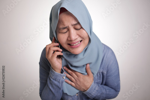 Muslim Woman Get Bad News when Talking on Phone, Sad Crying Expression