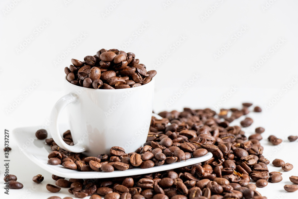 close up of white coffee cup in porcelain and grains of coffee isolated on white background with copy space. close up of white coffee cup in porcelain and grains of coffee isolated on white background with copy space.