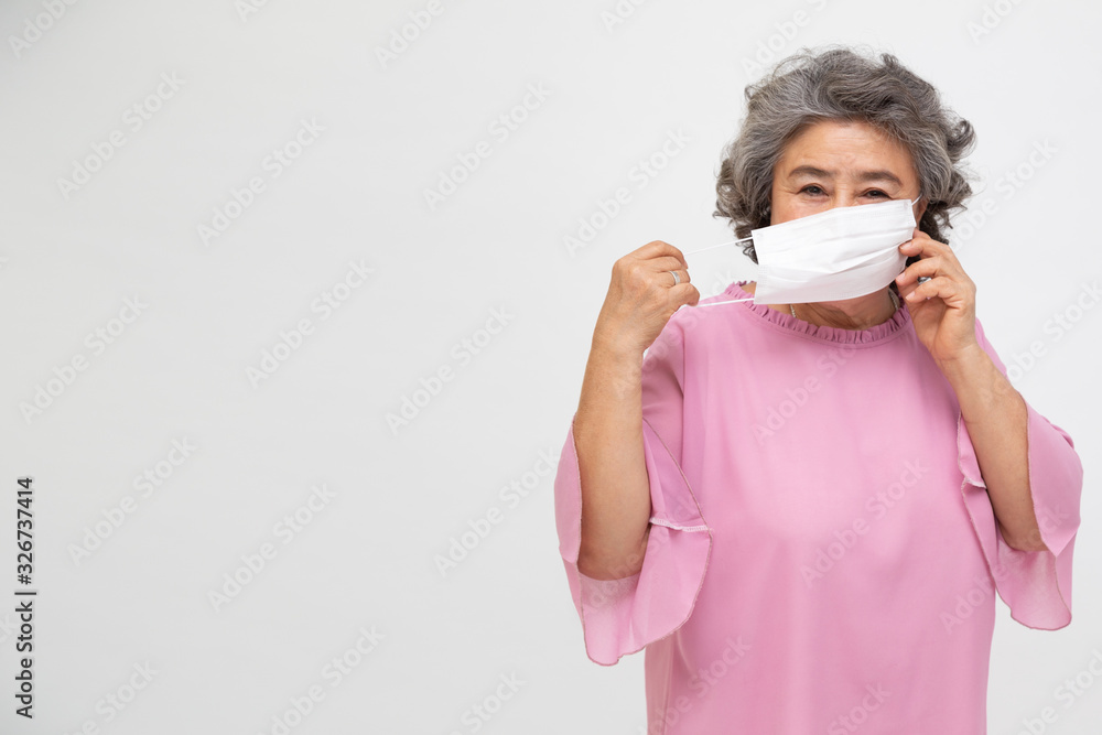 Asian senior woman wearing a protective face mask for plague coronavirus or covid-19 infectious disease. Facial hygienic mask for safety outdoor environmental awareness or virus spread concept Asian senior woman wearing a protective face mask for plague coronavirus or covid-19 infectious disease. Facial hygienic mask for safety outdoor environmental awareness or virus spread concept