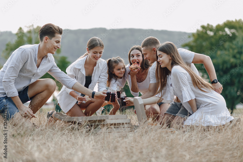 picnic friends with pizza and drinks drinking and eating with cheers, sunny day, sunset, company, fun, couples and mom with baby picnic friends with pizza and drinks drinking and eating with cheers, sunny day, sunset, company, fun, couples and mom with baby