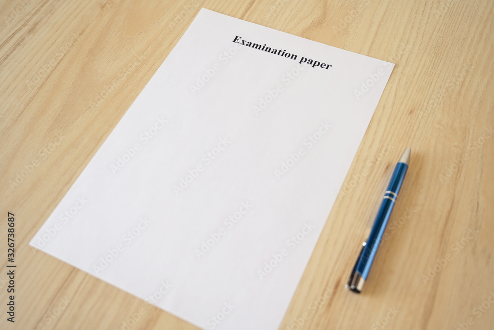 Empty examination paper for university with pen on the school desk. Copyspace. Mockup. Flat lay Empty examination paper for university with pen on the school desk. Copyspace. Mockup. Flat lay