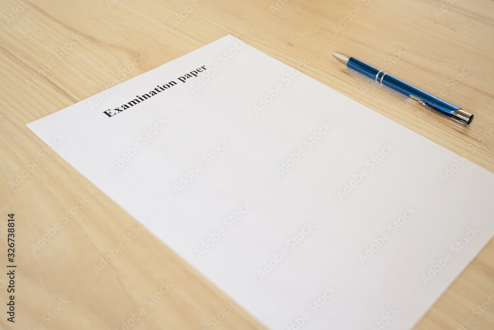Empty examination paper for university with pen on the school desk. Copyspace. Mockup. Flat lay Empty examination paper for university with pen on the school desk. Copyspace. Mockup. Flat lay