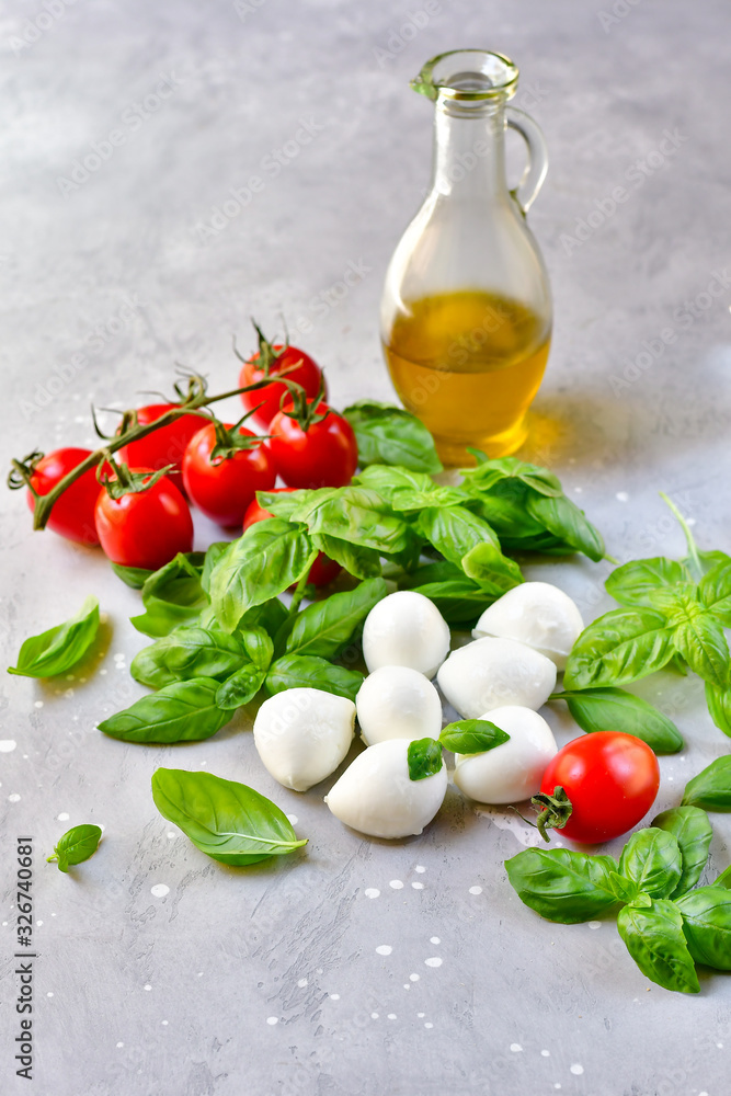 Italian caprese salad. Italy food Ingredients mozzarella buffalo, fresh basil, red tomatoes and olive oil. Italian cuisine, healthy lunch meal.  selective focus, copy space