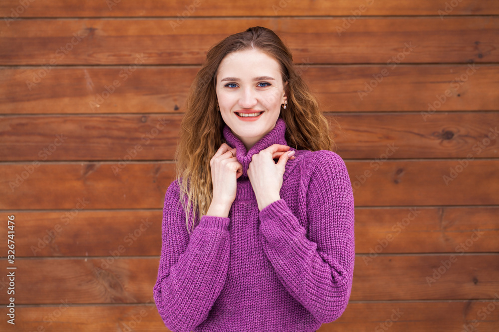 Portrait of a young beautiful woman in a lilac sweater Portrait of a young beautiful woman in a lilac sweater