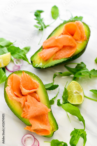 keto diet food : salmon and avocado with arugula and lime. healthy lunch. ketogenic diet food