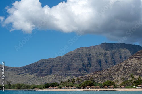 Makaha beach with mountains and blue cloudy sky photo