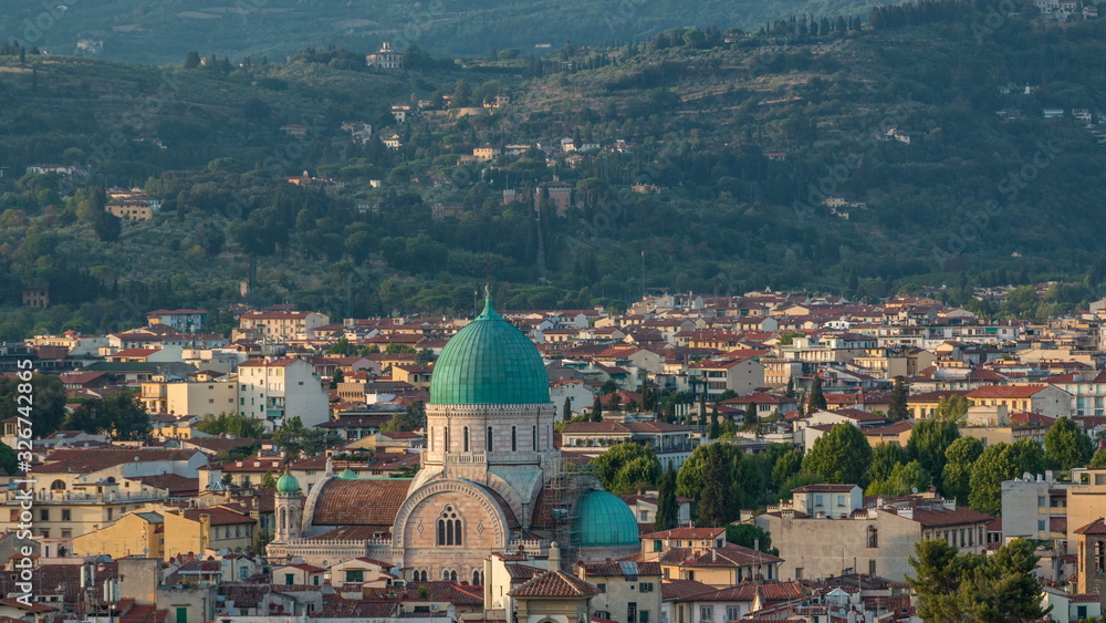 Fototapeta premium Synagogue of Florence timelapse with green copper dome rising above surrounding suburban housing with green hillside behind