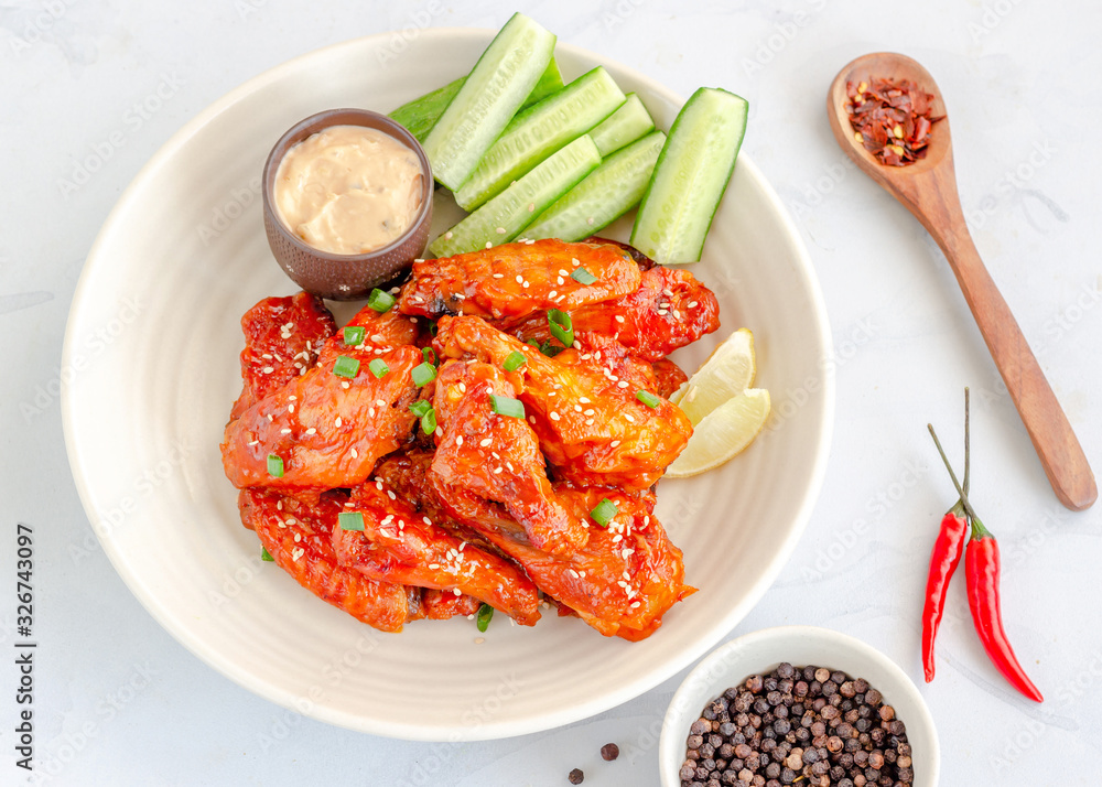 Spicy Baked Chicken Wings Served with Maonaisse Dip, Cucumber, Lemon, Red Chili, Black Pepper and Sesame Seeds, Top Down Horizontal Stock Photo Spicy Baked Chicken Wings Served with Maonaisse Dip, Cucumber, Lemon, Red Chili, Black Pepper and Sesame Seeds, Top Down Horizontal Stock Photo