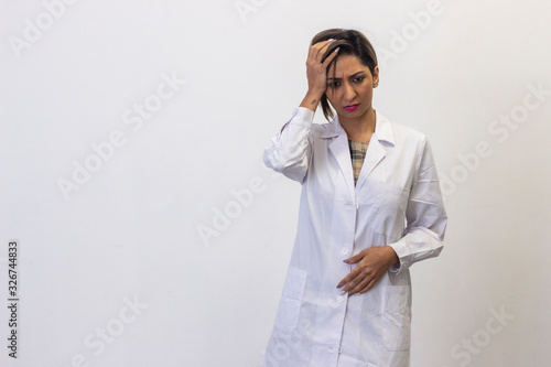 Portrait of attractive latin young woman with headache. Pharmacist, beauty therapist, doctor, nurse, scientist, beautician, healthcare, veterinarian, isolated on white background studio shot, in white