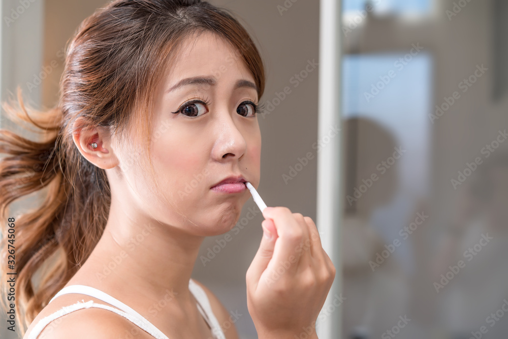 Beautiful young girl brushing teeth in front of her bathroom mir Beautiful young girl brushing teeth in front of her bathroom mir
