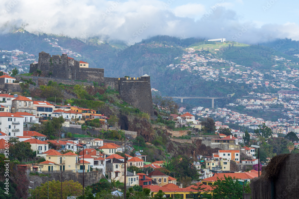 Funchal town and villages upp in the mountains with São João Baptista fortres to the left