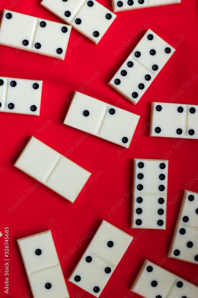 Dominoes Domino bones lie on a red fabric background. Dominoes Domino bones lie on a red fabric background.
