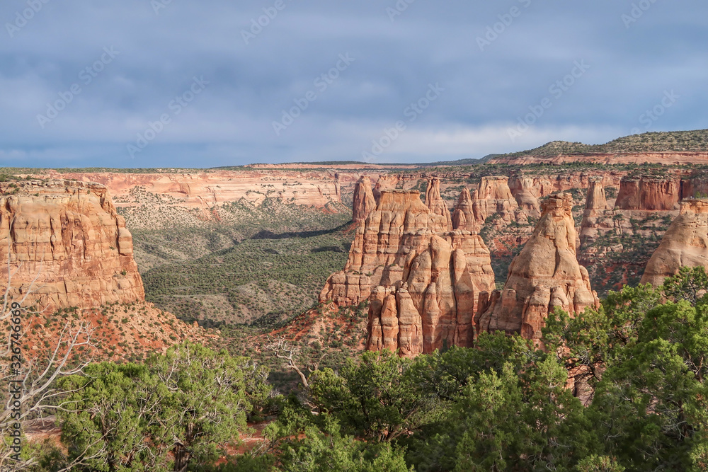 High angle landscape of valley and red and white stone pinnacles and formations at Colorado National Monument in Colorado High angle landscape of valley and red and white stone pinnacles and formations at Colorado National Monument in Colorado