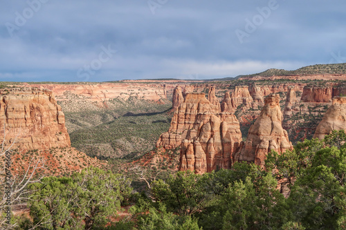 High angle landscape of valley and red and white stone pinnacles and formations at Colorado National Monument in Colorado