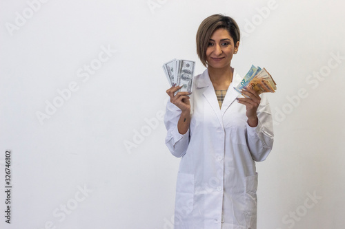 Portrait of pretty latin young woman model with euros and euros in hands, banknotes. Doctor, nurse, pharmacist, beauty therapist, scientist, ophthalmologist, optometrist, beautician, healthcare, isola