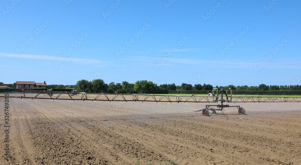 large industrial automatic irrigation system in a cultivated fie