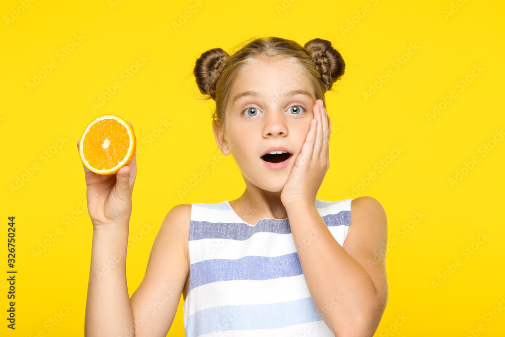 Young girl with orange fruit on yellow background Young girl with orange fruit on yellow background