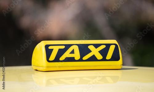 Taxi sign yellow coloe detail, defocused city street background