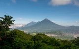 Acatenango and Fuego Volcanoes in Guatemala seen from behind vegetation