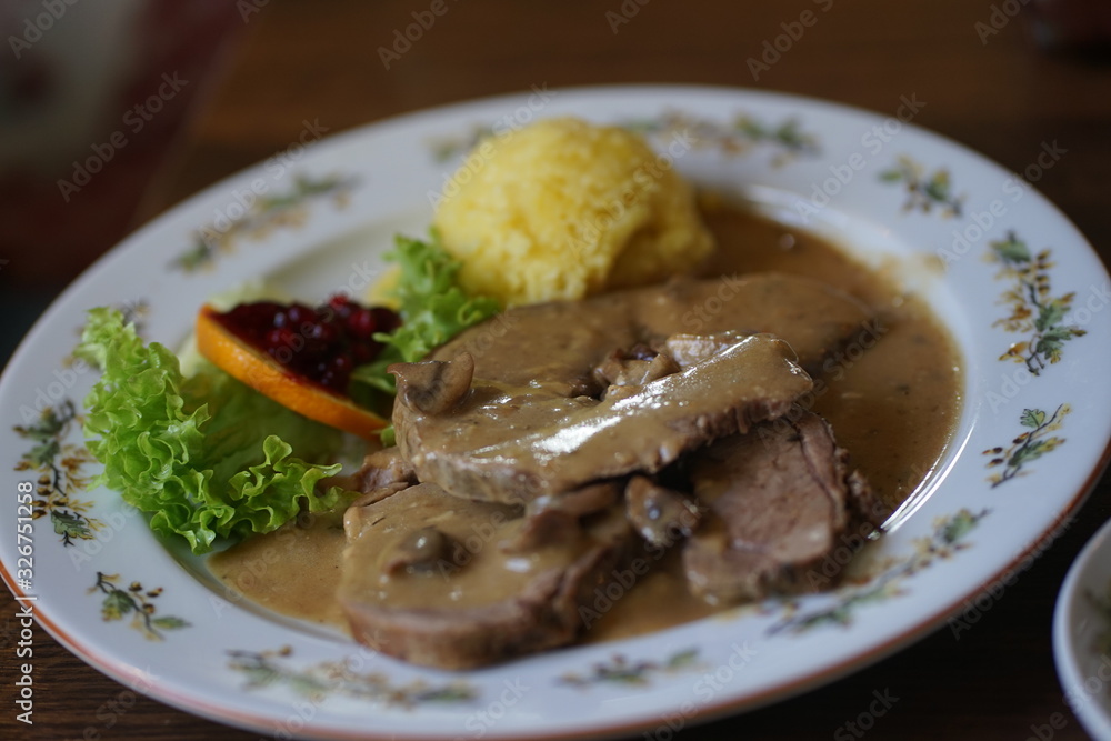 Traditional roast wild boar dish at german game restaurant