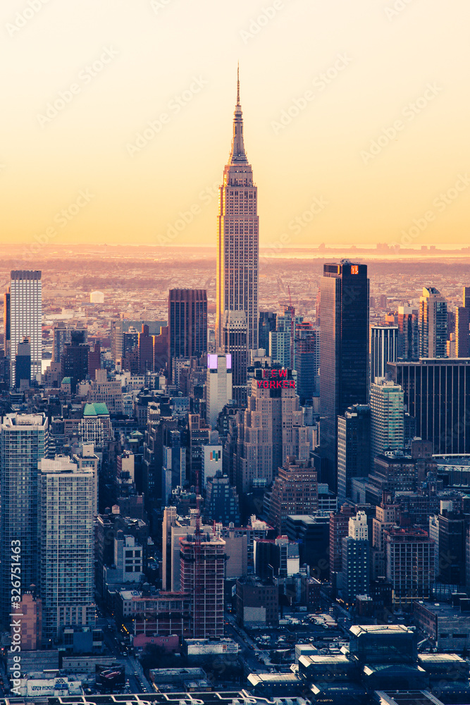 Empire State Building NYC Skyline at dawn.  Golden warm tones telephoto
