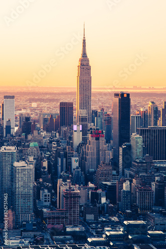 Empire State Building NYC Skyline at dawn. Golden warm tones telephoto