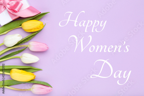 Text Happy Womens Day with tulip flowers and gift box on purple background