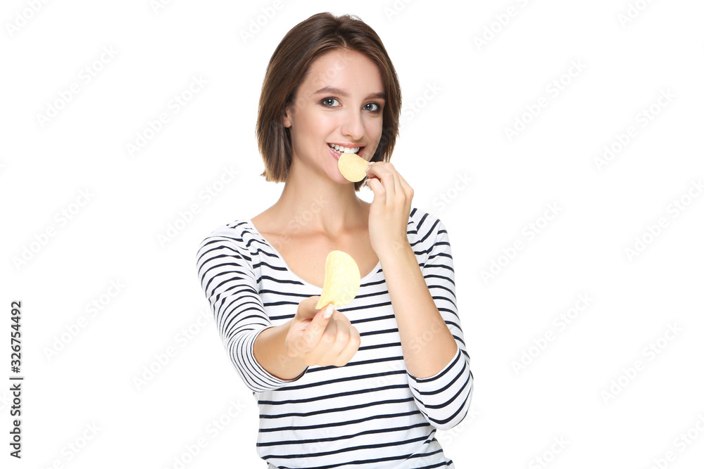 Beautiful young woman eating potato chips on white background Beautiful young woman eating potato chips on white background
