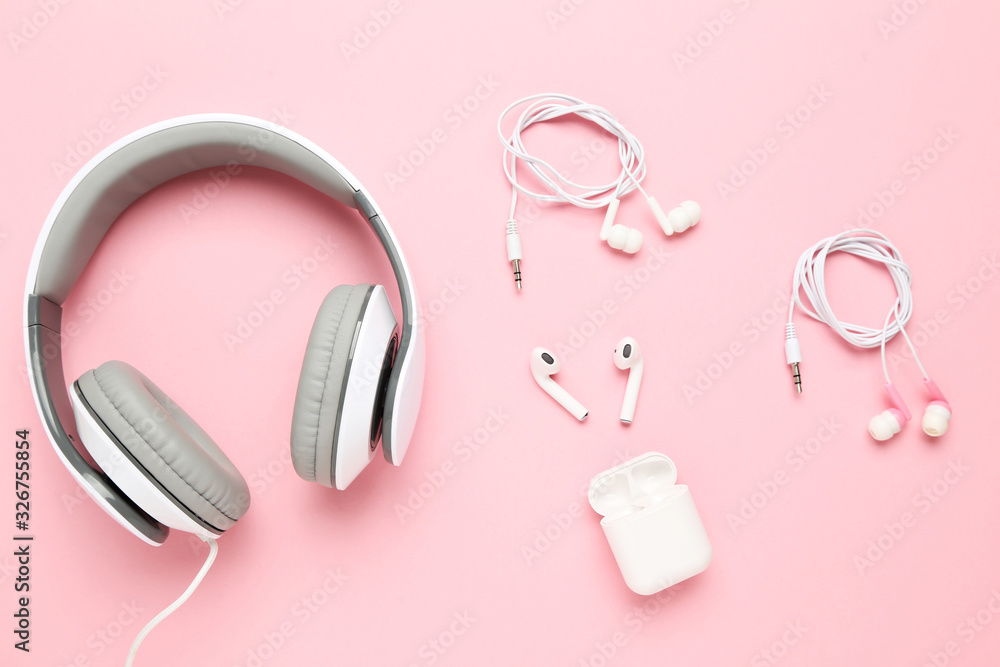 Three different earphones on pink background
