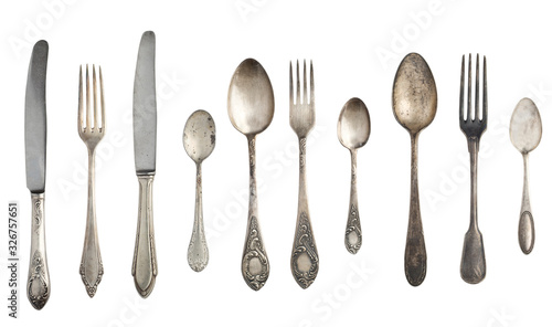Beautiful old vintage forks. spoons and knife isolated on white background. Top view. Retro silverware