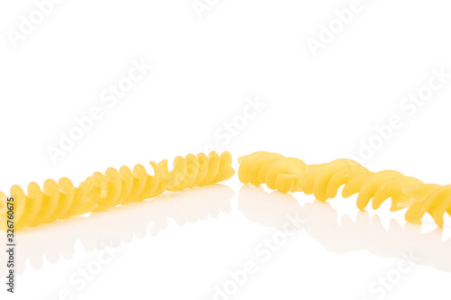 Group of six whole yellow pasta fusilli isolated on white background