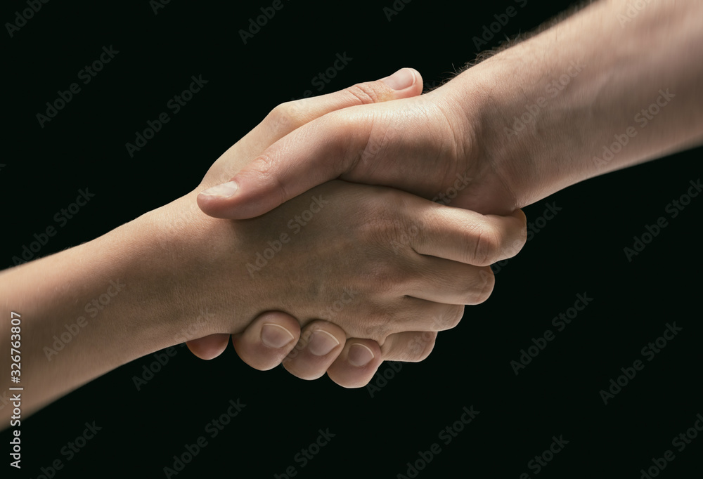 Concept of rescue. Image of the hands of two people during the rescue. On black background. Concept of rescue. Image of the hands of two people during the rescue. On black background.