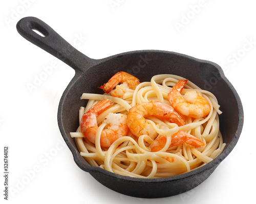 Shrimps with pasta in the iron pan photo