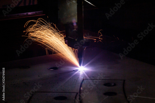 Plasma cutting of metal with a cnc. Plasma cutting machine cutting steel sheet. Laser cutter in production. Industrial metal cutting by plasma laser