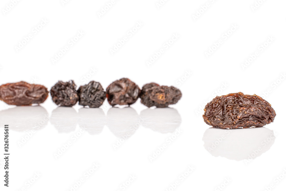 Group of six whole dried dark raisin isolated on white background Group of six whole dried dark raisin isolated on white background