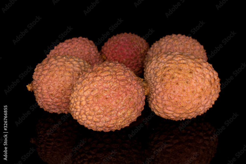 Group of six whole fresh lychee circle isolated on black glass Group of six whole fresh lychee circle isolated on black glass