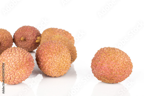 Group of seven whole fresh lychee isolated on white background