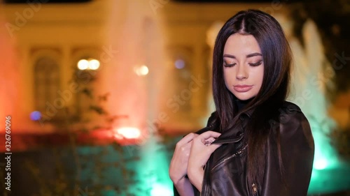 Wallpaper Mural Portrait of a beautiful young woman at night in the city. Attractive brunette girl in a black jacket looking to camera. City lights background. Female portrait. Torontodigital.ca